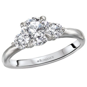 This beautiful 14kt white gold engagement ring has two round diamonds on either side of a setting that will accommodate another 6.5mm round diamond. (D 1/3 carat total weight)
