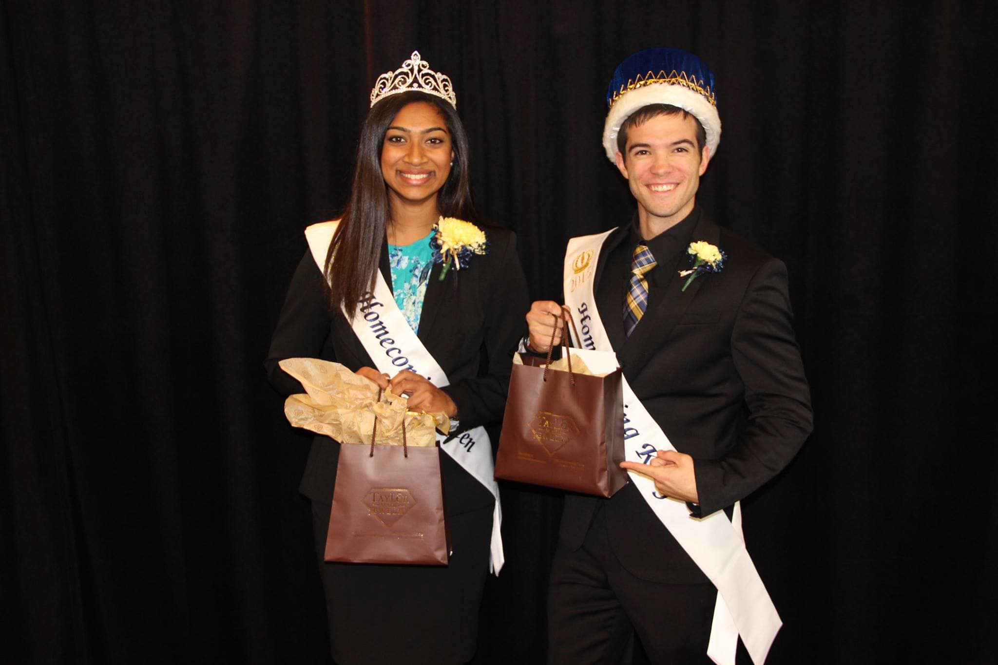 Homecoming King and Queen posing with gifts sponsored by TMJ