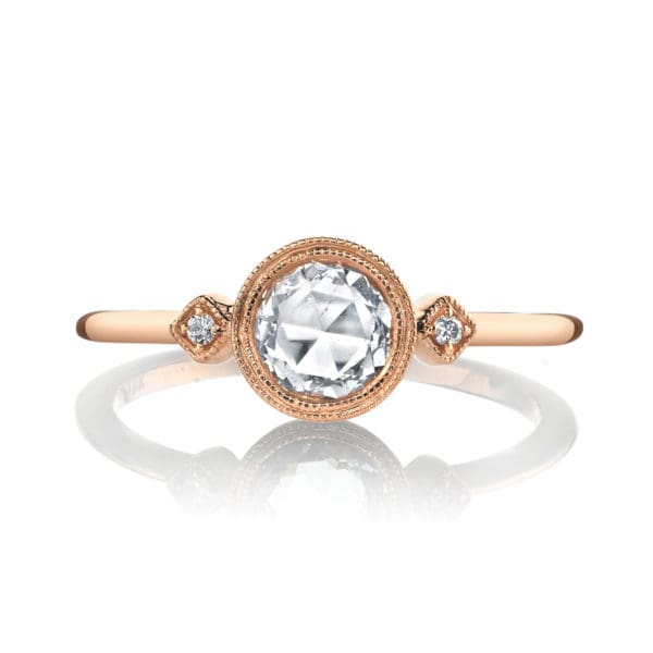 A half carat rose-cut diamond rests in a golden bezel, accented by brilliant white diamonds and finished with fine milgrain detailing in this charming design from the Lumiere Bridal Collection.